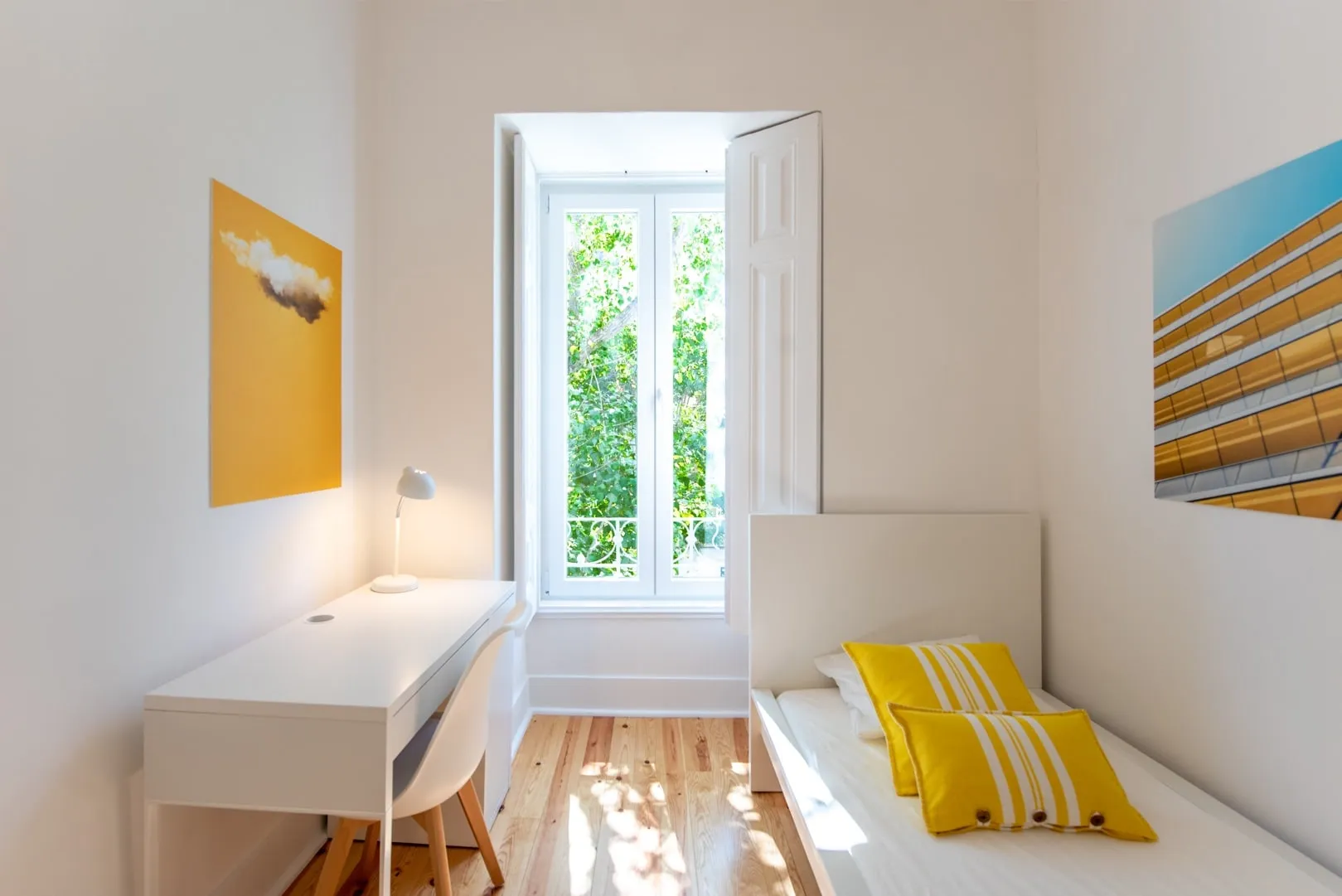 A sunny single room with a large window